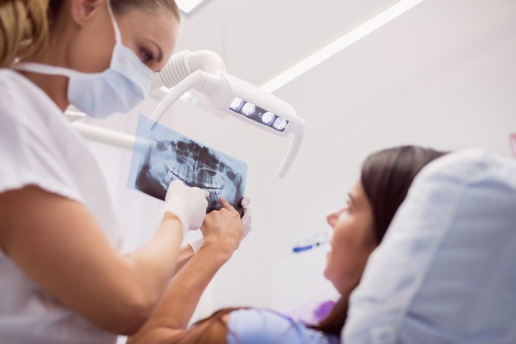 Doctor showing x-ray to the patient